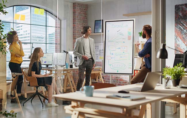 Team collaborating on whiteboard SEO strategy – on-page and technical SEO planning session