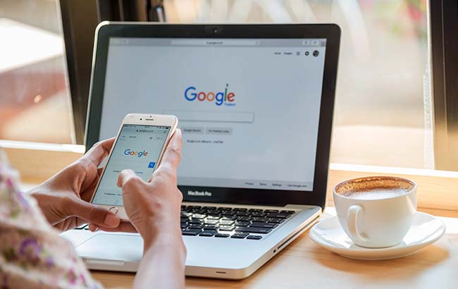 User browsing Google on laptop and smartphone — Google remarketing and display ads strategy