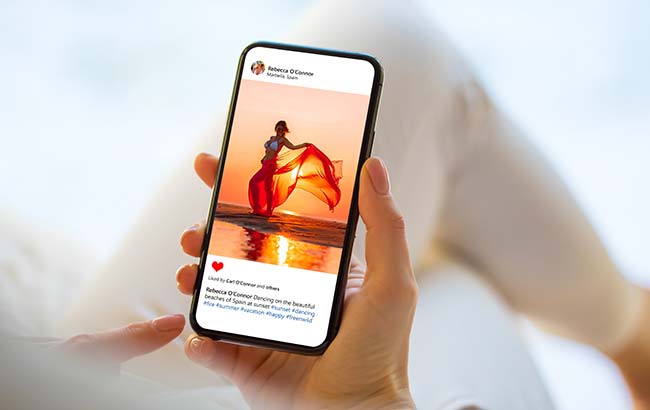 Person viewing Instagram ad on smartphone featuring lifestyle content at sunset