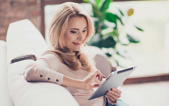 Person using tablet for online search and shopping — SEM advertising concept